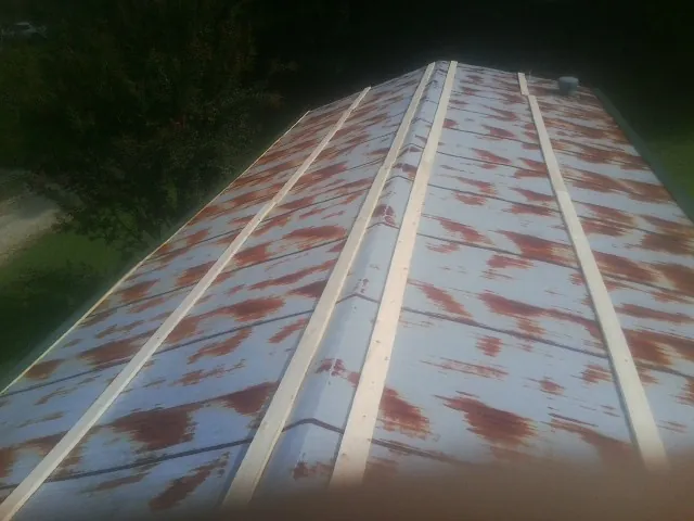 Rusted metal roof panels with new wood purlins before replacement — Storm Damage Roof Repair in Greencastle by Roofing Brothers