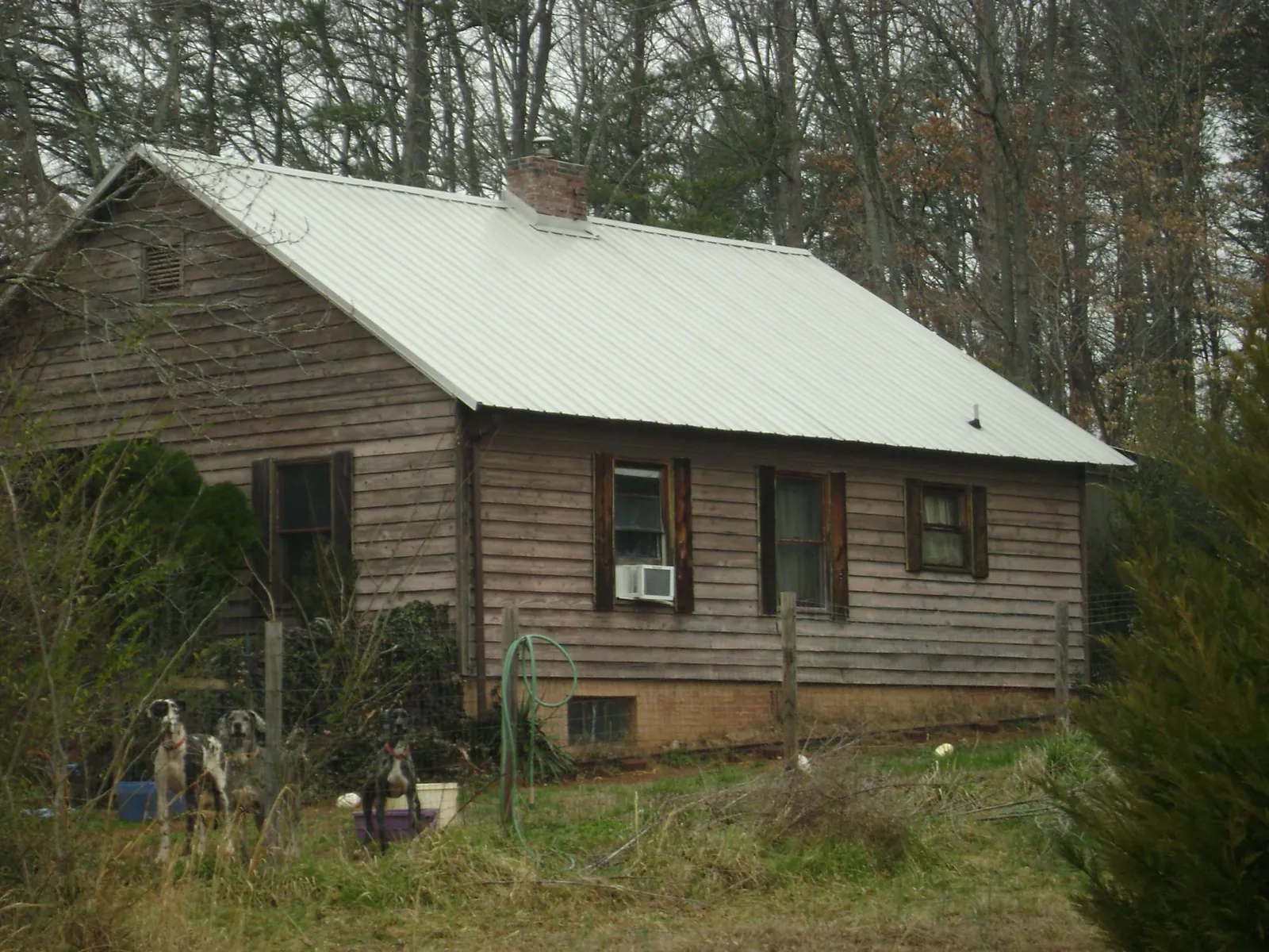 White metal roof on an old wood sided farmhouse, from a Metal Roof Installation job in Greencastle
